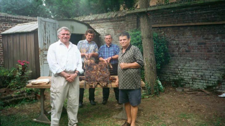 Caudry pedmar,dad and inlaws being shown how to roast a pig sept95