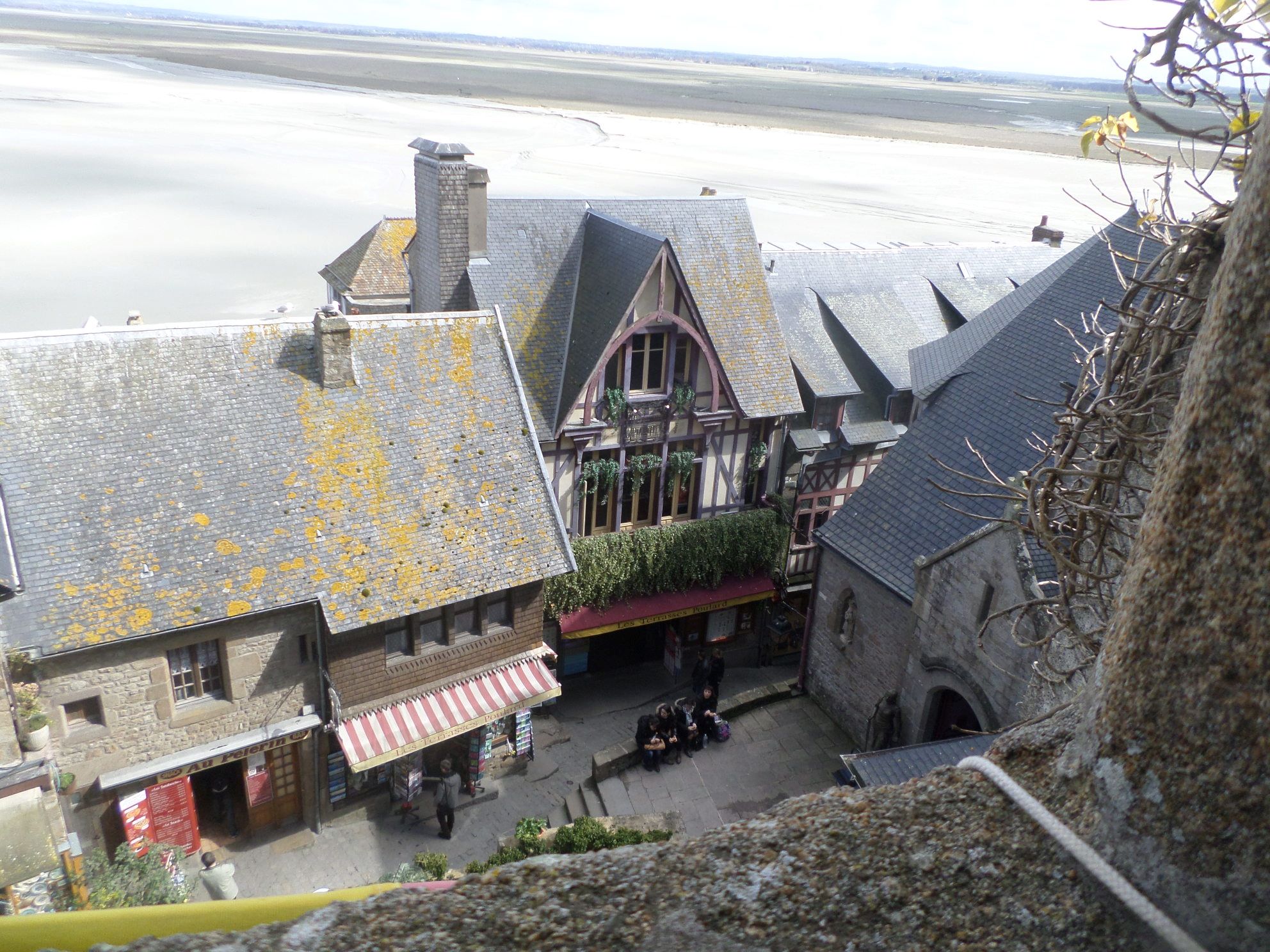Mont Saint Michel abbey to ch st pierre right and businesses from above mar15